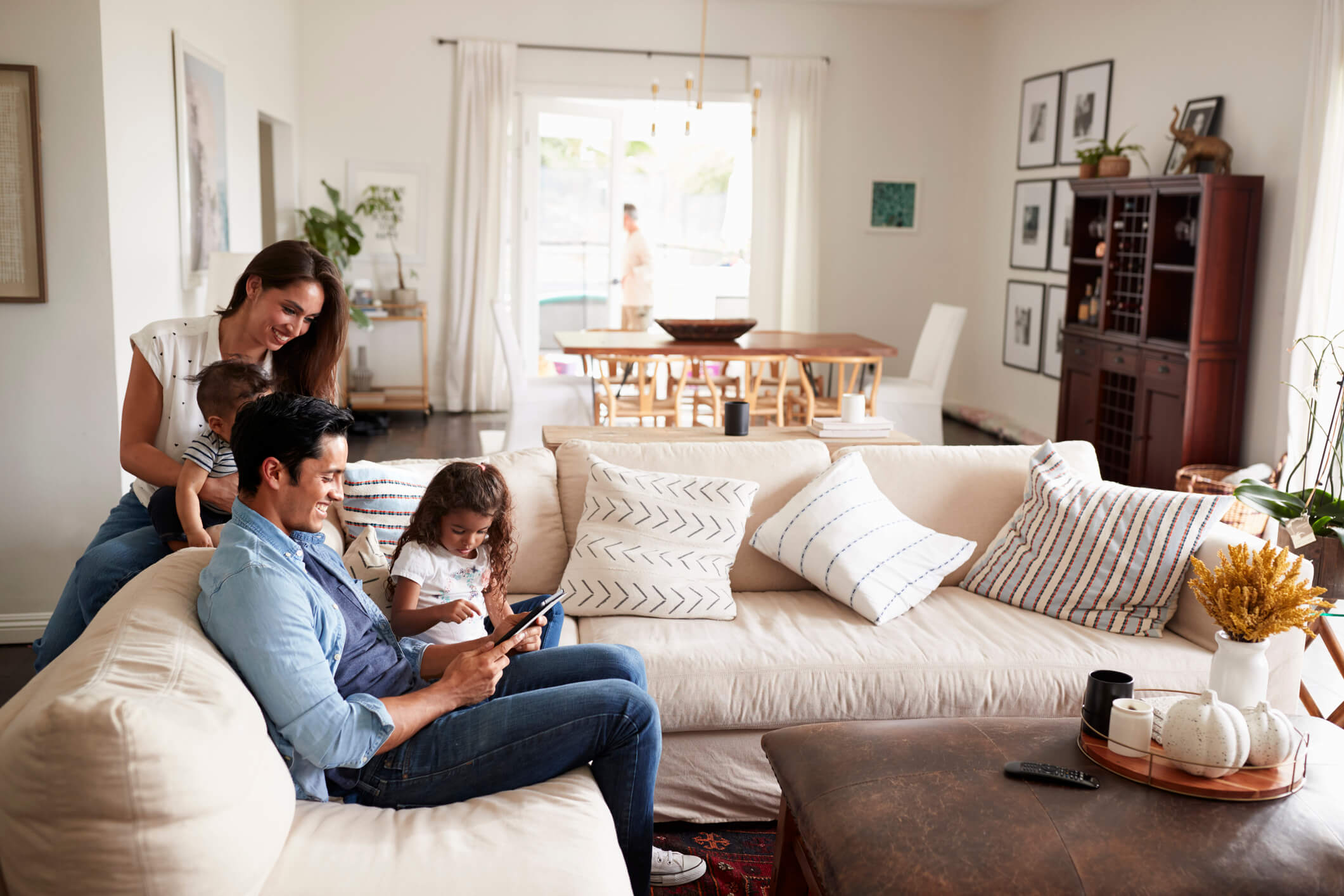 Family on couch with tablet